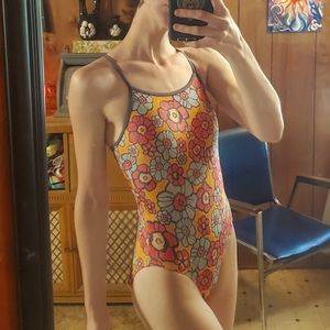 Pink and blue flowers pattern on a yellow one piece swimsuit